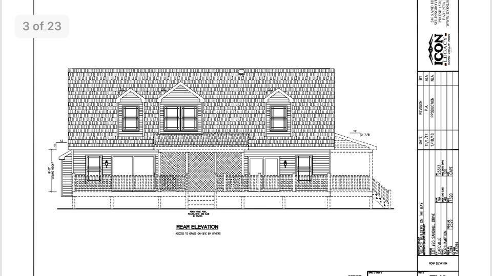 Technical drawing of the rear elevation of a building. It features two stories with shingled gables and four symmetrical windows. Architectural notes are on the side.