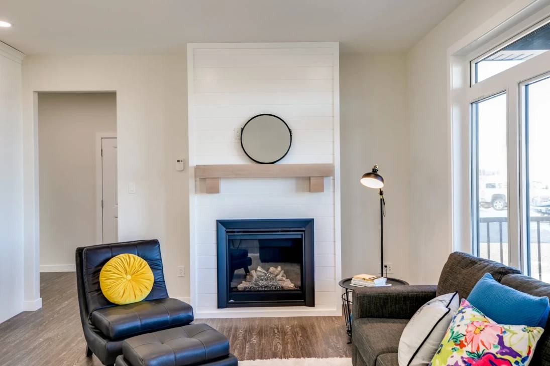A cozy living room featuring a fireplace and a comfortable couch, creating a warm and inviting atmosphere.