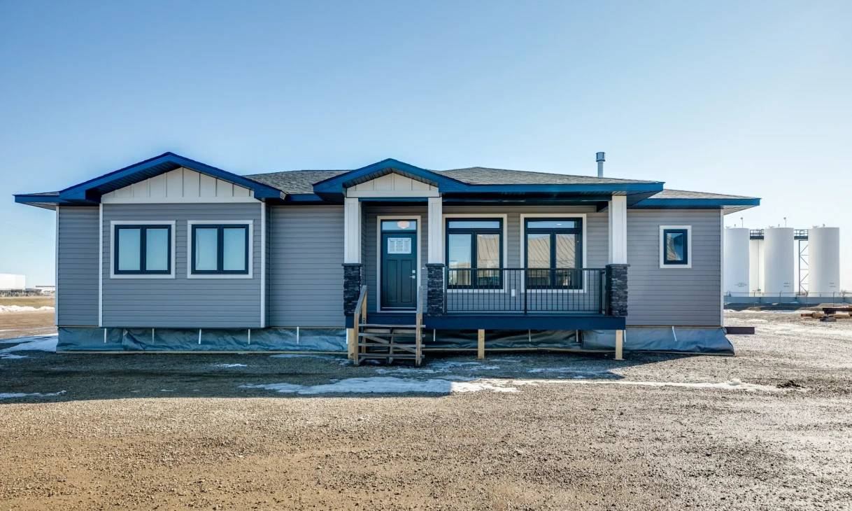 A house featuring gray siding accented with blue trim around the windows and doors.