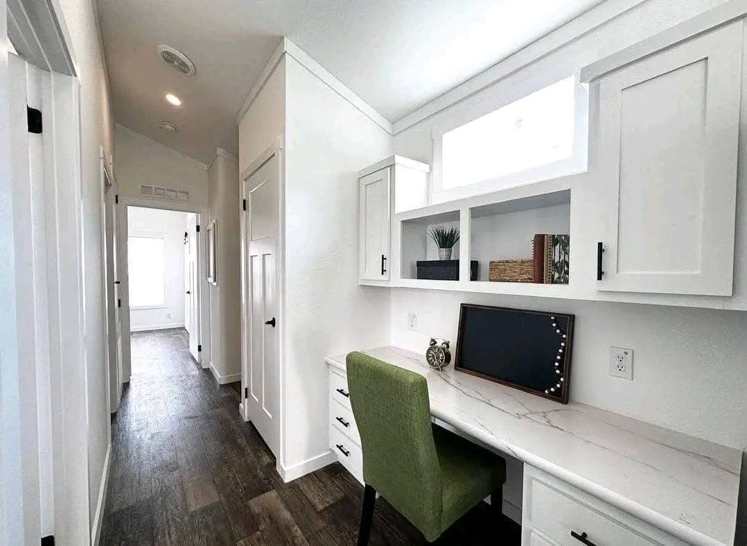 A cozy tiny home interior featuring a desk and a chair, designed for efficient use of space.
