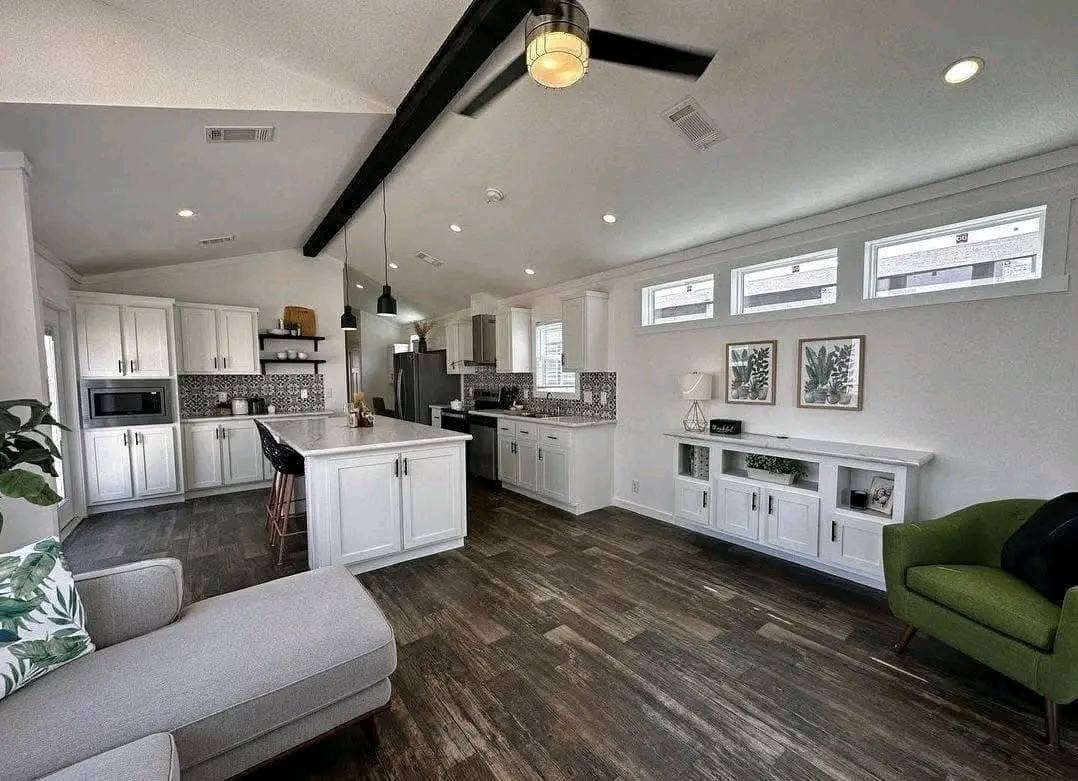 A photo showing a kitchen and living room, featuring modern decor and open space design.