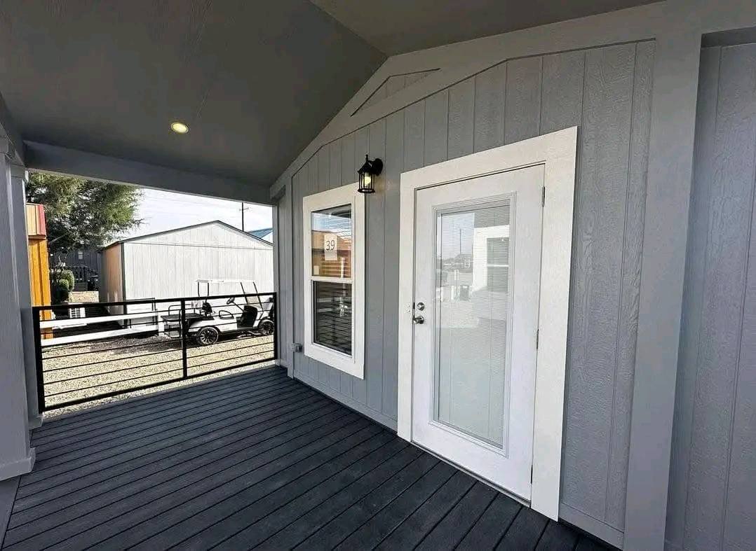 Front porch of a tiny home featuring a welcoming door and cozy seating area.