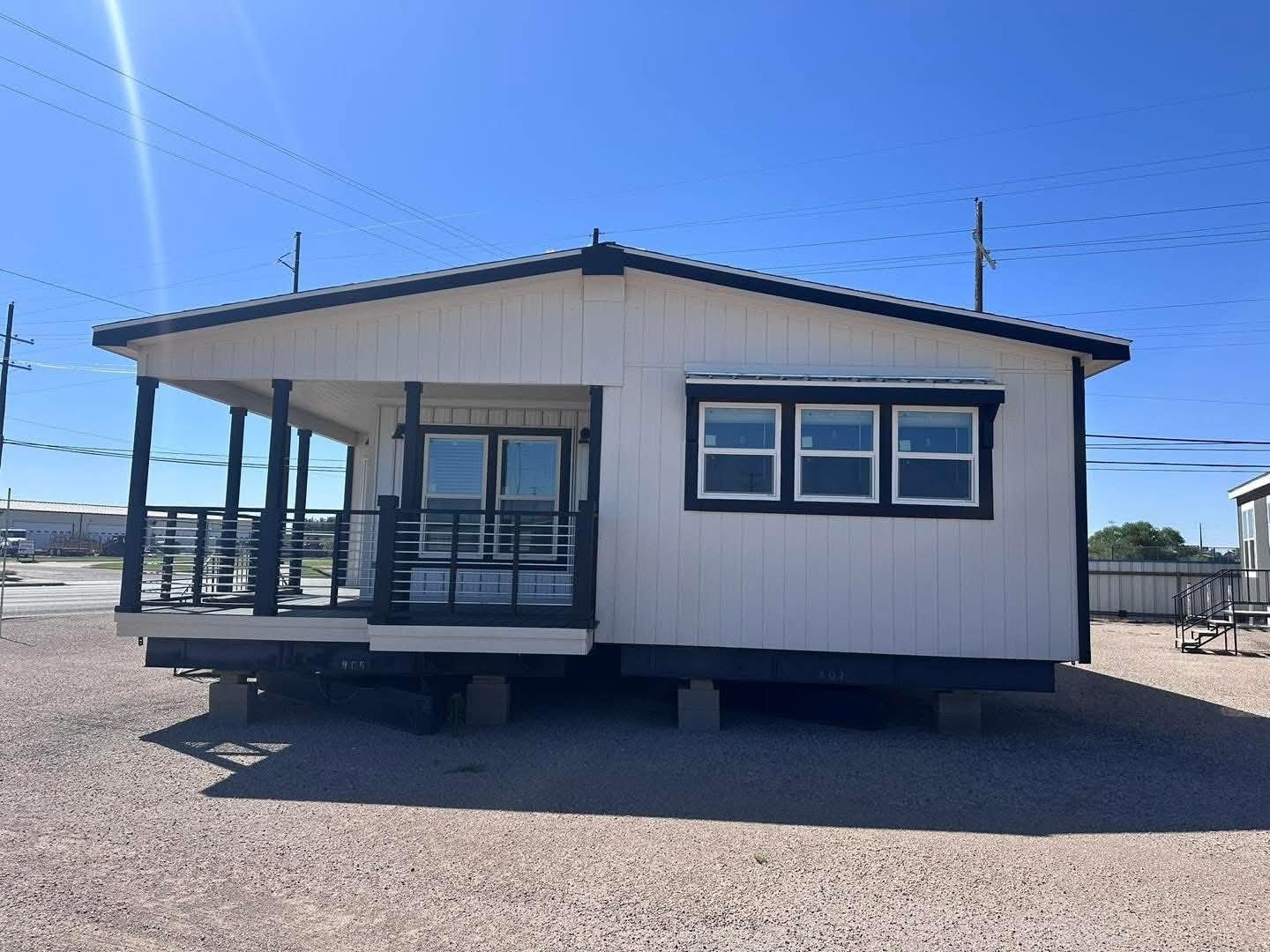 A tiny home situated on a spacious lot, showcasing its compact design amidst the surrounding landscape.