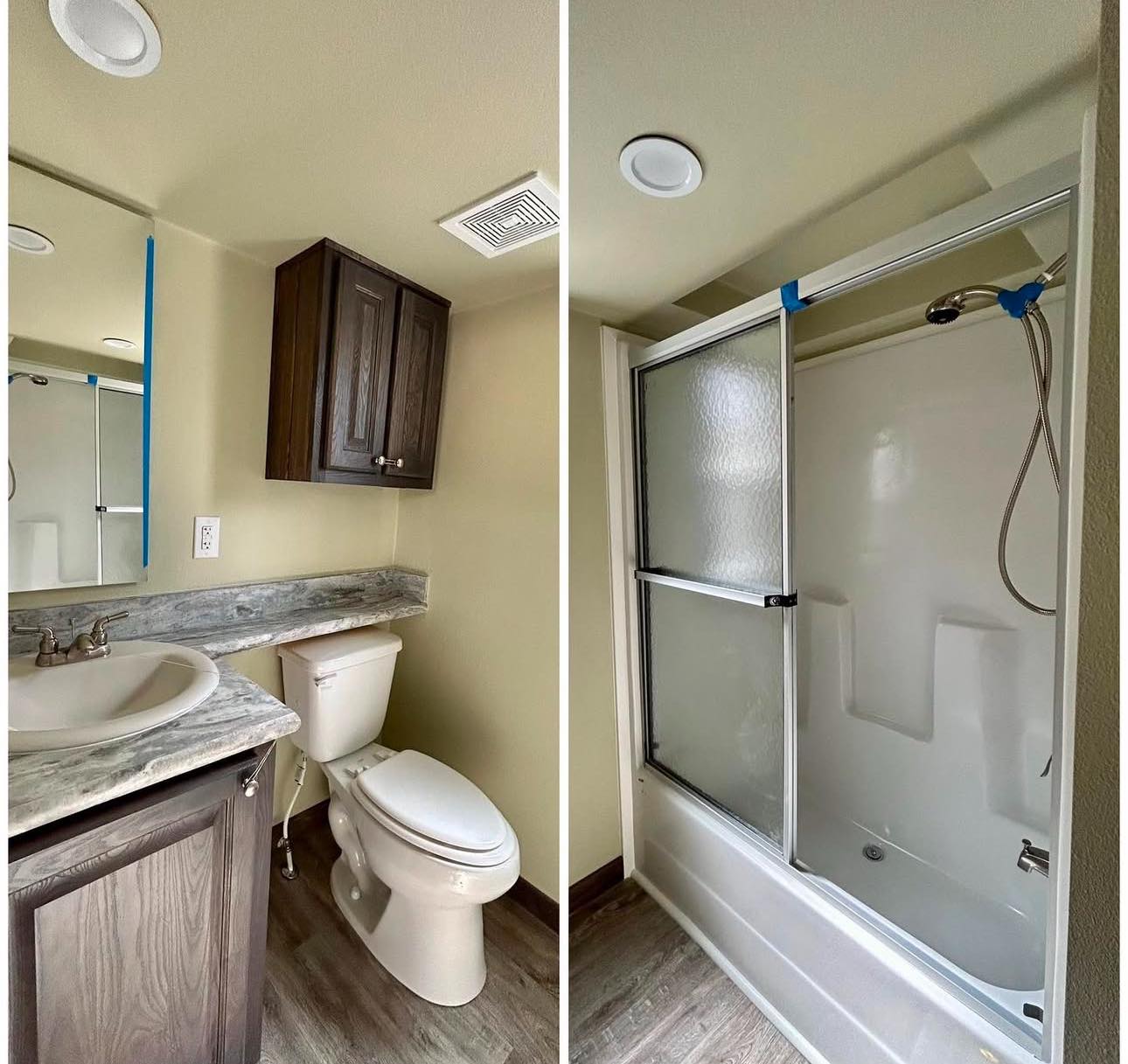 Compact bathroom with light wood flooring, showcasing a white sink, marbled countertop, dark wood cabinet, toilet, and shower with frosted glass doors.