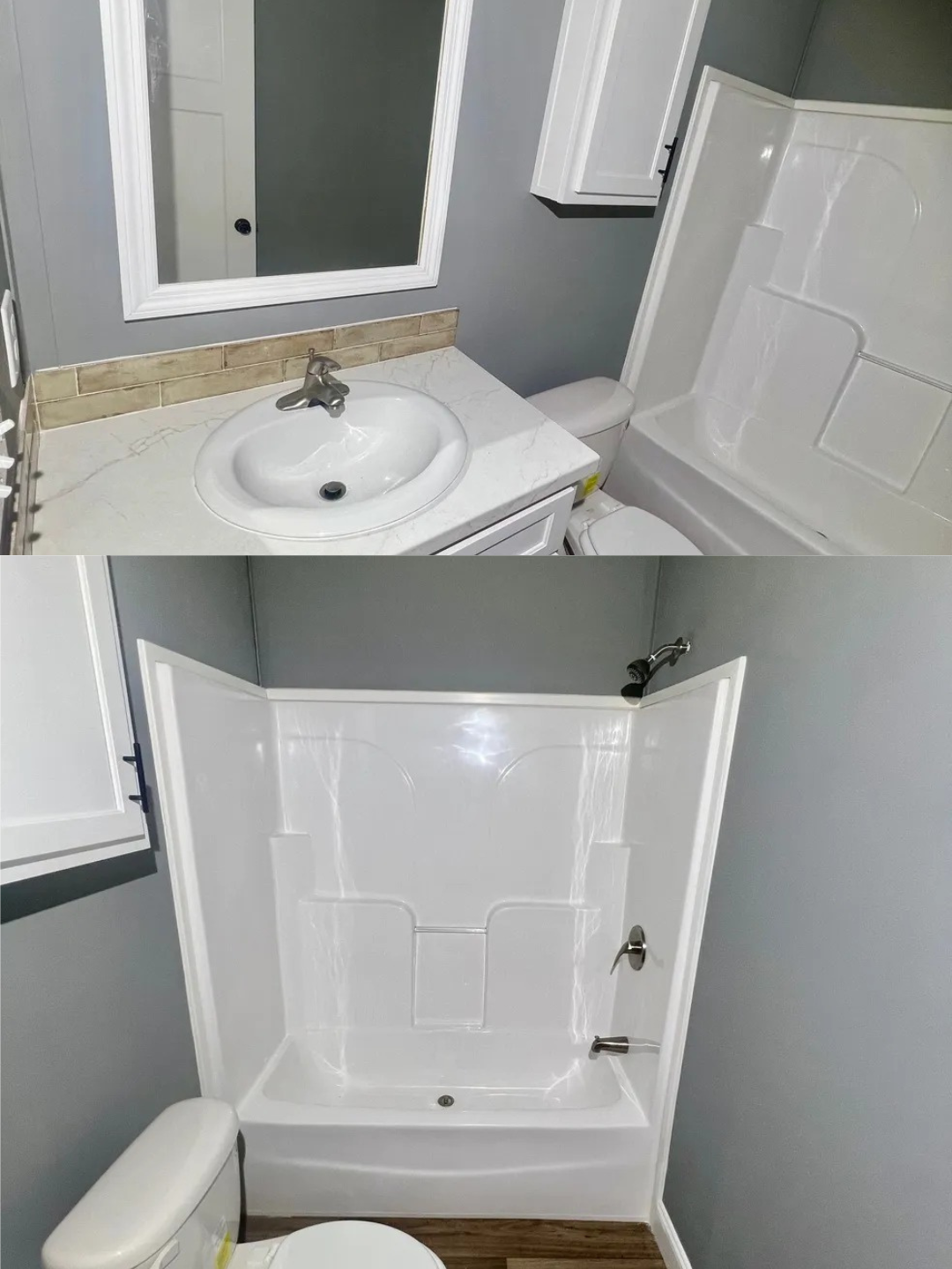 A modern bathroom with gray walls and wood flooring. It features a white sink with a chrome faucet, a bathtub with a showerhead, and a toilet nearby.