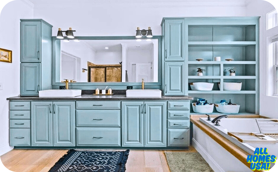 Modern bathroom featuring light blue cabinetry, dual sinks, a large mirror, open shelving, and a soaking tub by a wooden deck. Image for illustrative purpose.