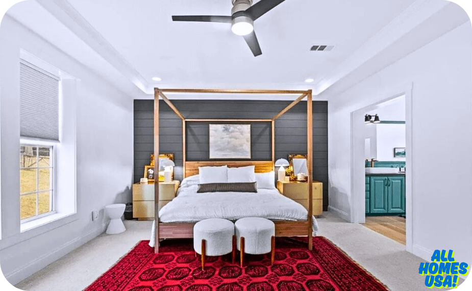 Stylish bedroom featuring a wooden canopy bed, red rug, modern decor, and an adjoining bathroom. Bright and inviting atmosphere. Image for illustrative purpose.