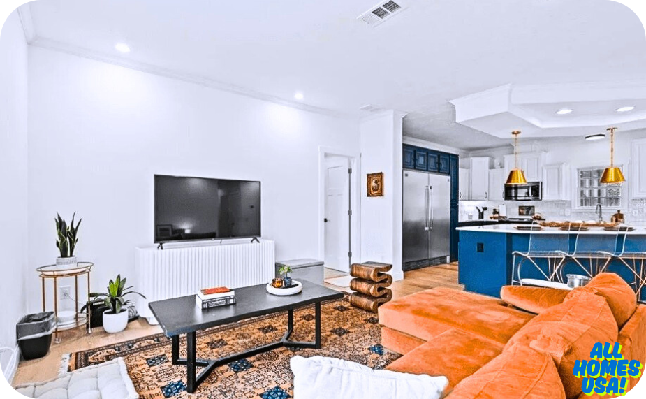 Living room with television, plants, and orange couch. Image for illustrative purpose.