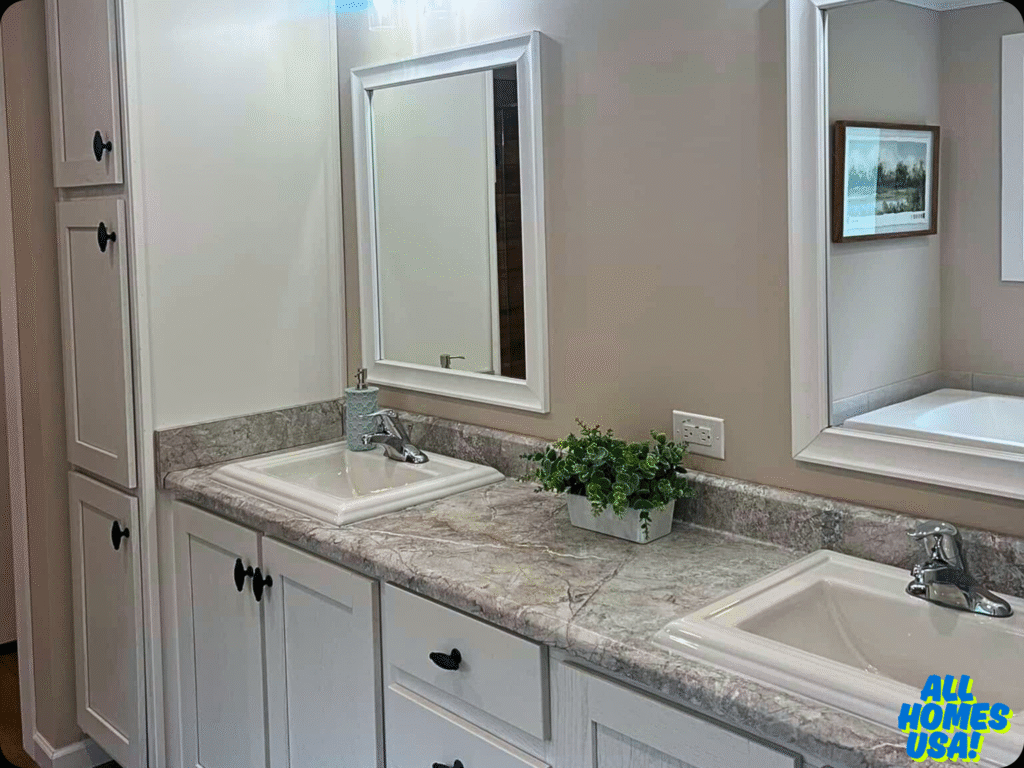 Double-sink bathroom vanity with marble countertop, white cabinets, and framed mirrors. Decor includes a small green plant, creating a clean, serene atmosphere. Image for illustrative purposes.