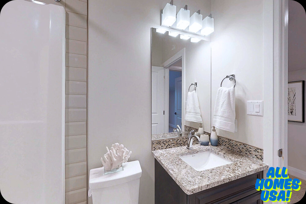 A modern bathroom with a granite countertop and sleek fixtures. A white coral decoration is on the toilet, and towels hang neatly. Bright and serene. Image for illustrative purpose.