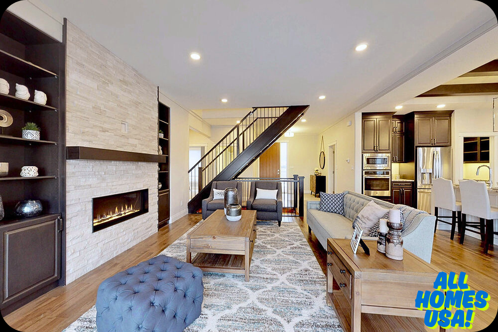 Modern living room with a stone fireplace, sleek shelving, and plush seating. Open kitchen, dining area, and staircase add spaciousness. Cozy yet elegant ambiance. Image for illustrative purpose.