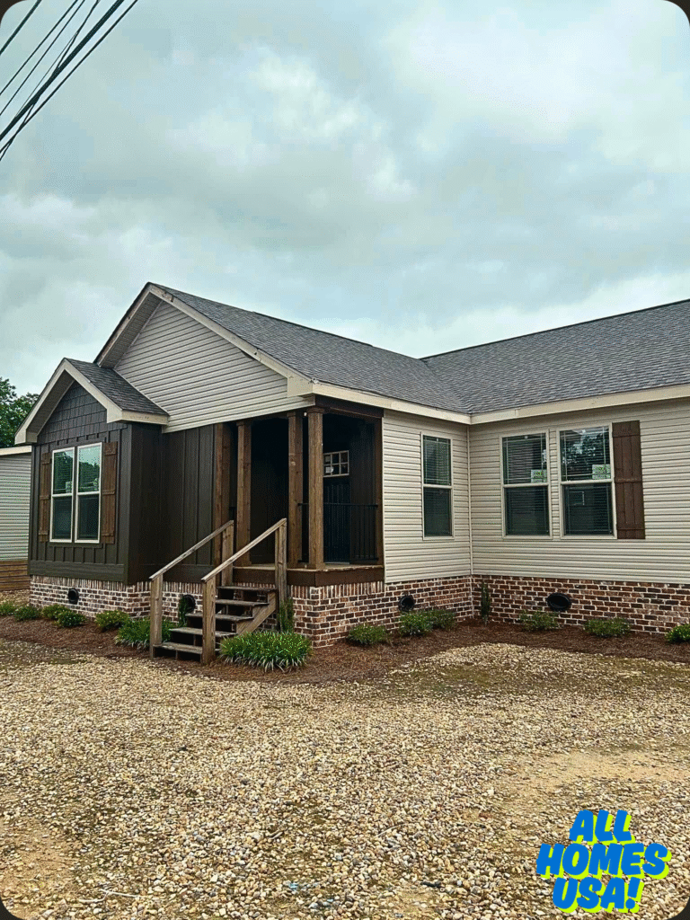 One-story house with a mix of beige siding and brown accents. Brick foundation, front porch with steps, overcast sky, and logo "All Homes USA!" at the bottom right. Image for illustrative purpose.