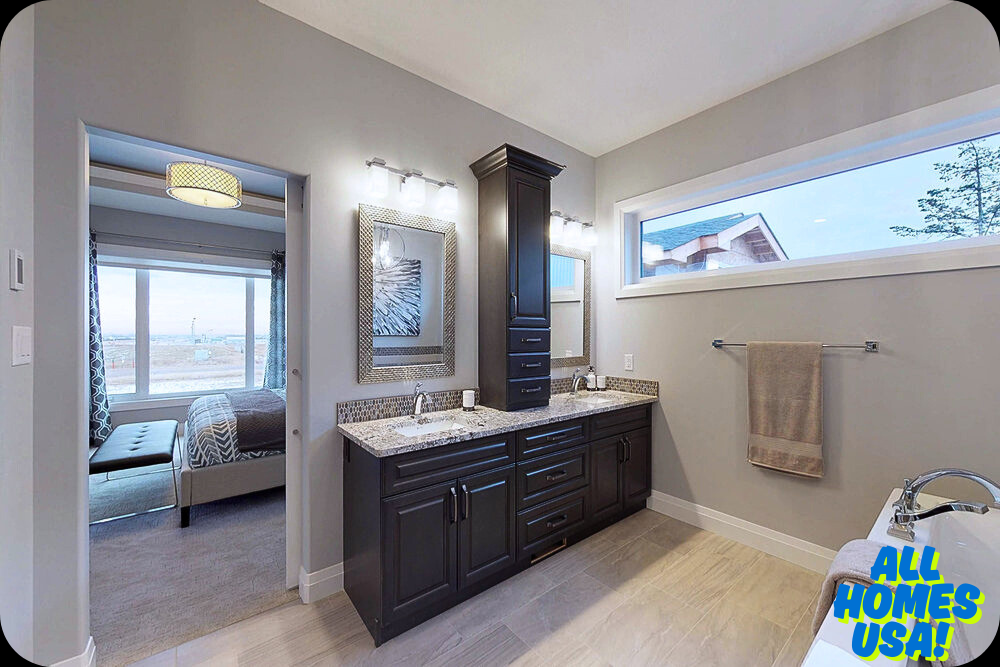 Spacious bathroom with double vanity and granite countertop. A mirror reflects modern lighting. A bedroom is visible through an open doorway. Cozy and elegant atmosphere. Image for illustrative purpose.