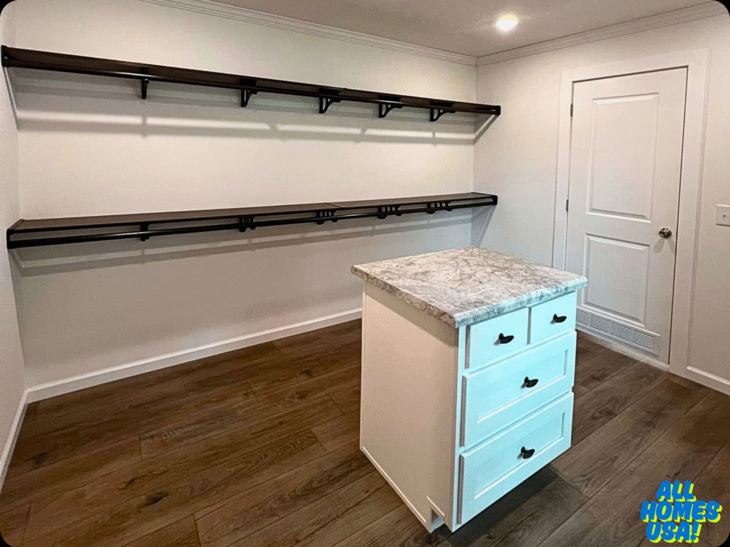 A minimalist storage room features dark wood shelves on white walls, a marble-topped island with drawers, and a white door. The room has a neat, organized feel. Image for illustrative purposes.