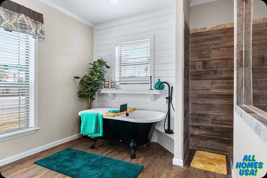 Luxurious bathroom featuring a black clawfoot tub with teal towels, wooden flooring, a potted plant, and a tiled shower, exuding a tranquil ambiance. Image for illustrative purpose.