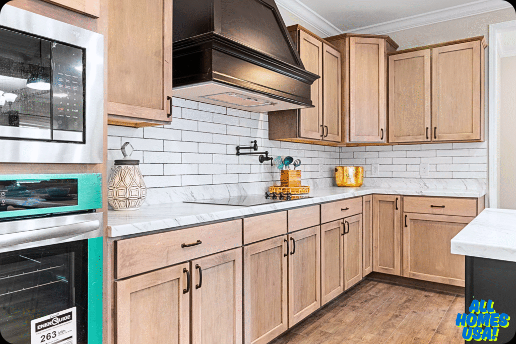Modern kitchen with light wood cabinets, white subway tile backsplash, and marble countertops. Features a black range hood and stainless steel oven. Image for illustrative purpose.