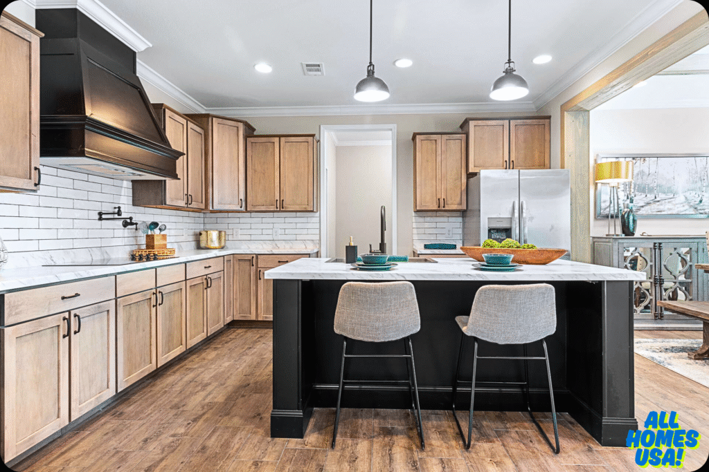 Modern kitchen with light wood cabinets, white subway tiles, and a black range hood. Features a marble island with two gray barstools and elegant decor. Image for illustrative purpose.