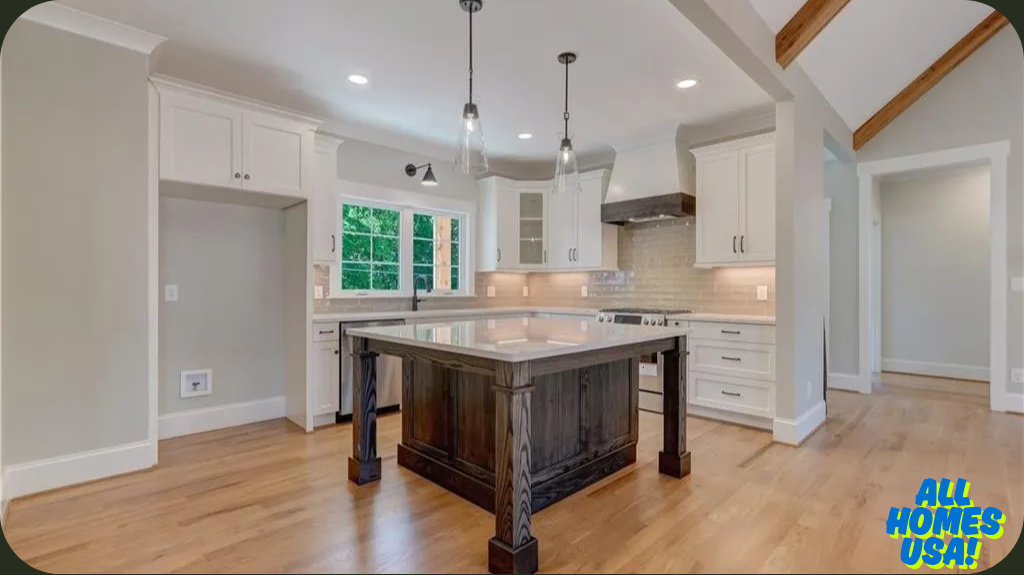 Spacious kitchen with light wood floors, cream cabinets, and dark wood island. Pendant lights and large windows add brightness, creating a welcoming atmosphere. Image for illustrative purposes.