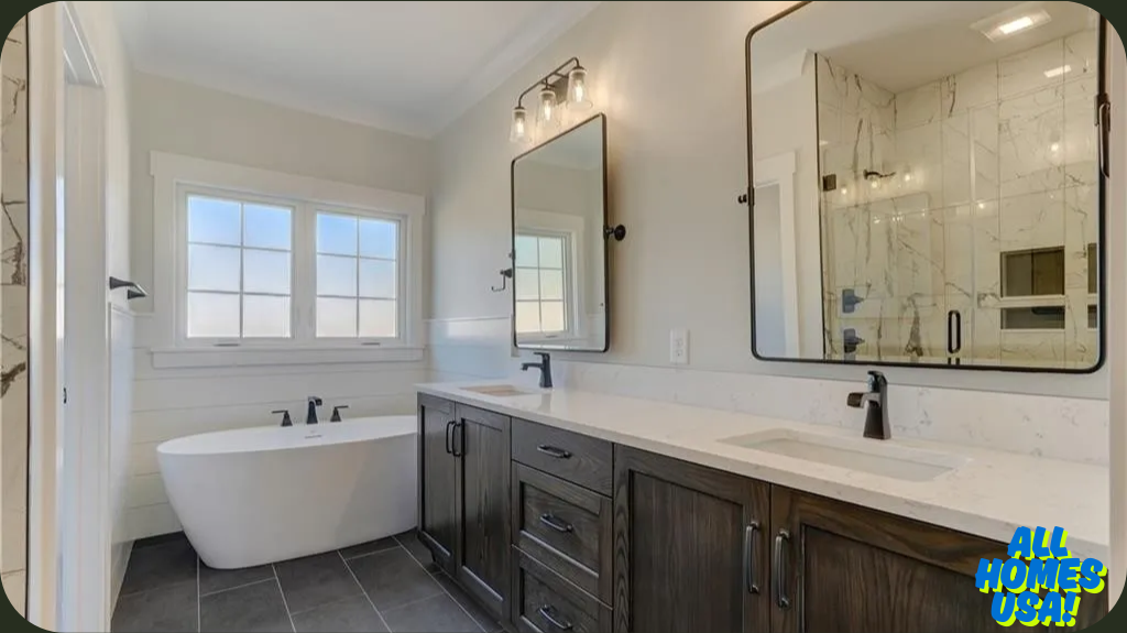 Modern bathroom with a freestanding white tub under a window. Double vanity with dark wood cabinets, large mirrors, and black fixtures. Warm, inviting tone. Image for illustrative purposes.