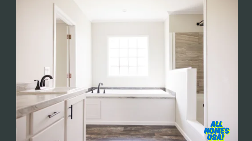 Bright, modern bathroom with a large window, bathtub, and separate shower. Features sleek fixtures and wood-patterned floor. Logo: All Homes USA! Image for illustrative purposes.