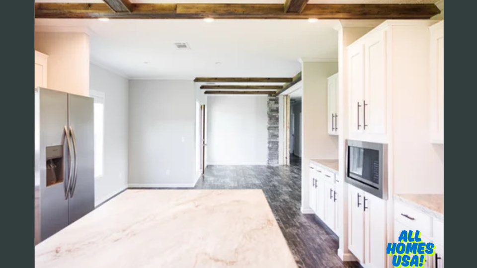 Bright kitchen with white cabinets, stainless steel appliances, and a marble countertop. Exposed wooden beams and stone accents add rustic charm. Image for illustrative purposes.